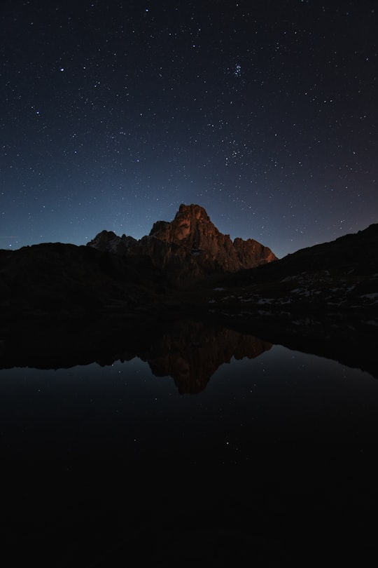 lake near mountain during night in Rolle Pass Italy