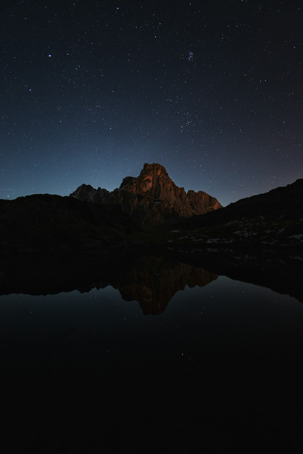 lake near mountain during night