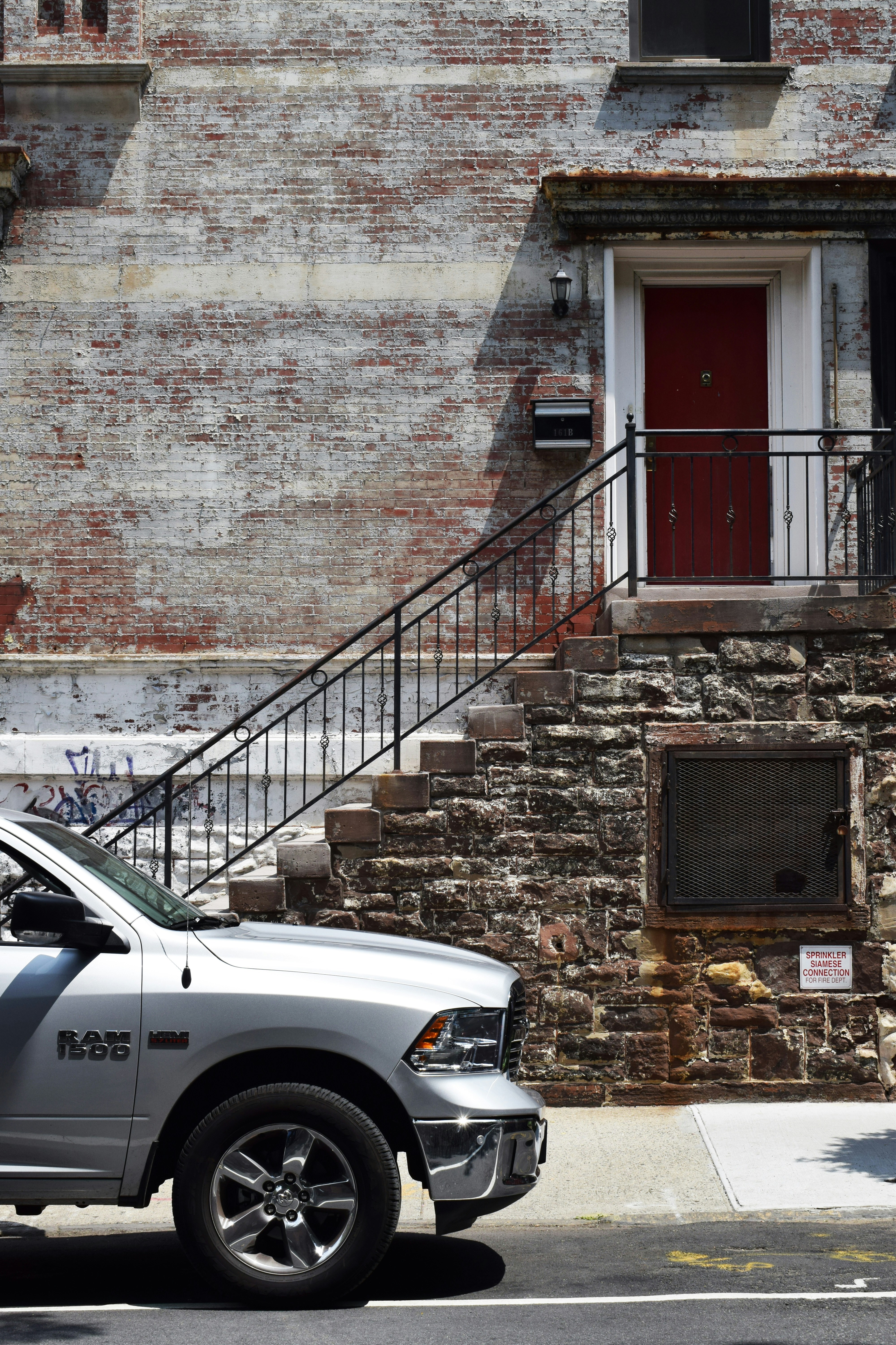 silver Dodge Ram 1500 near brown brick wall