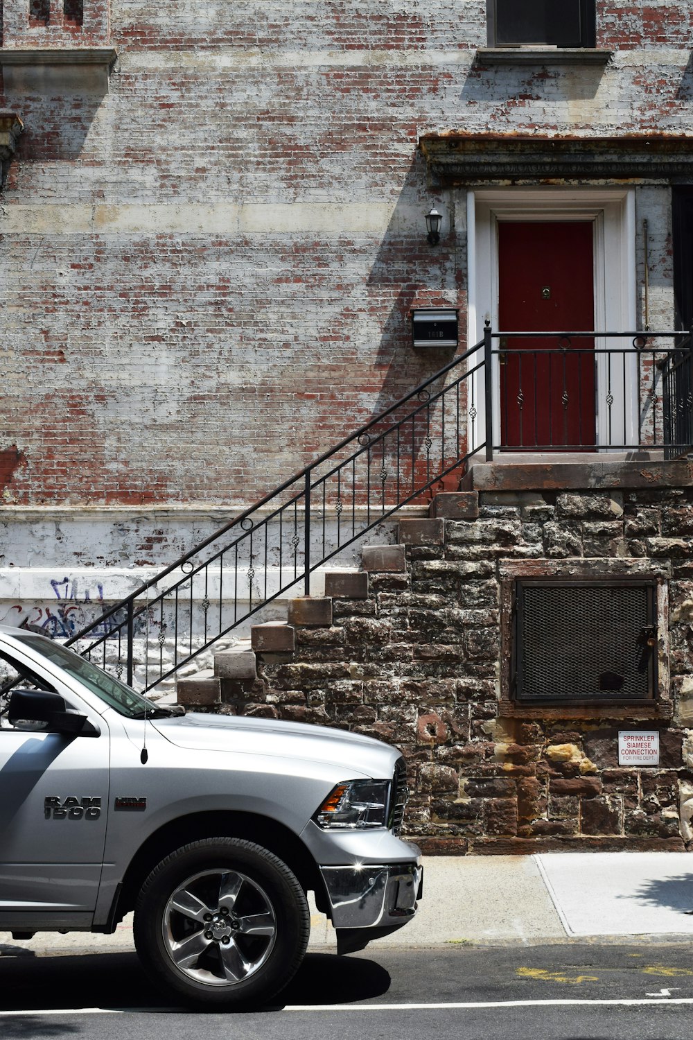 silver Dodge Ram 1500 near brown brick wall