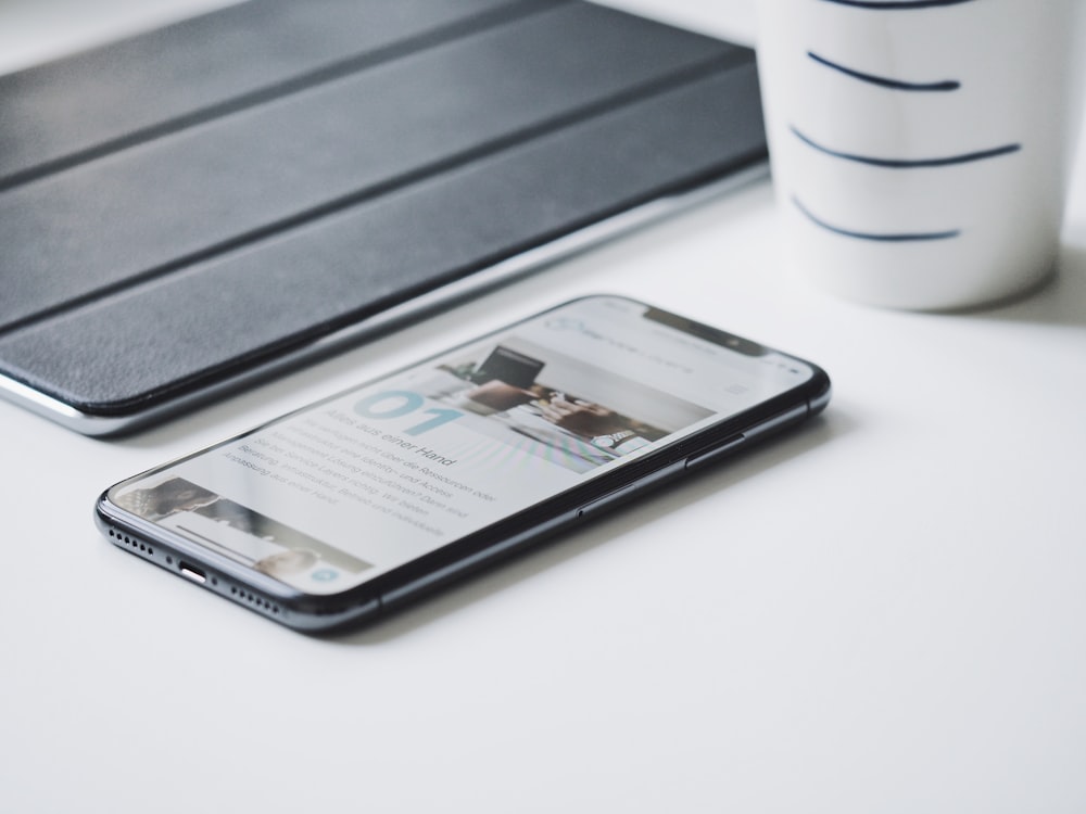 black smartphone beside black smart case