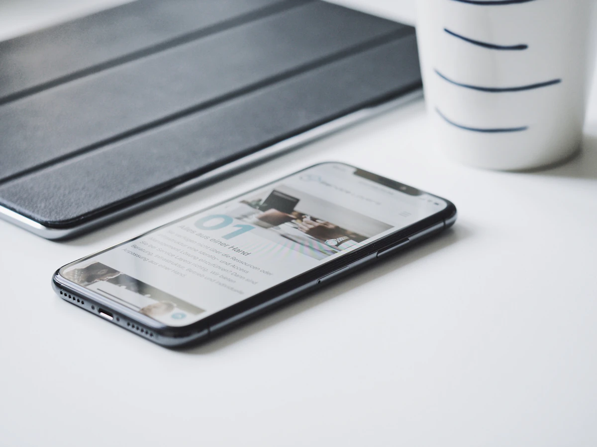 Black smartphone beside black smart case