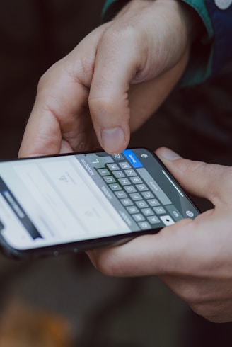 selective focus photography of person using smartphone