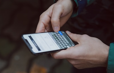 selective focus photography of person using smartphone