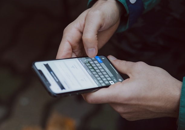 selective focus photography of person using smartphone