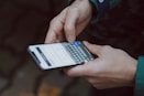selective focus photography of person using smartphone