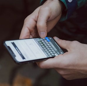 selective focus photography of person using smartphone