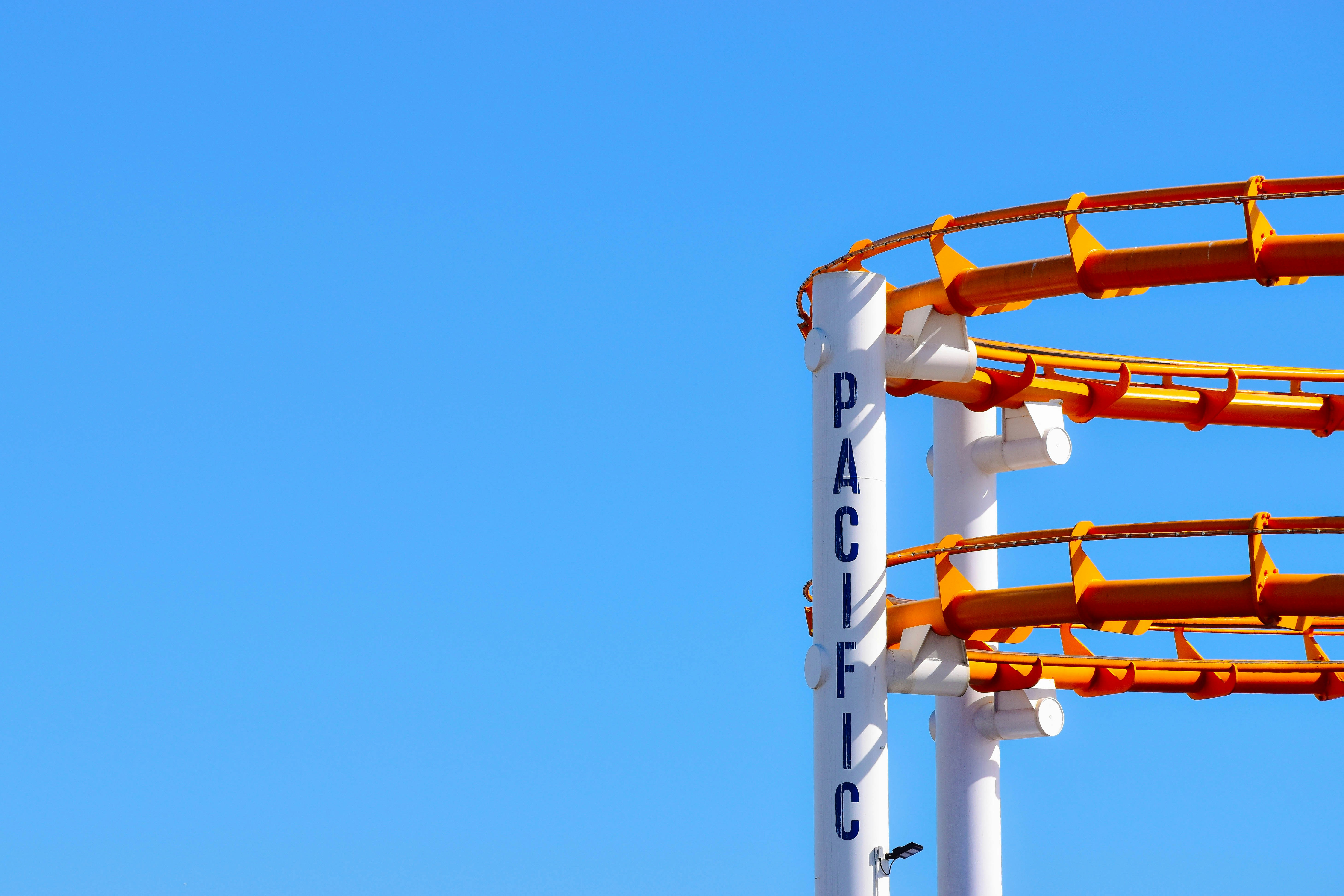 roller coaster under blue sky rollercoaster teams background