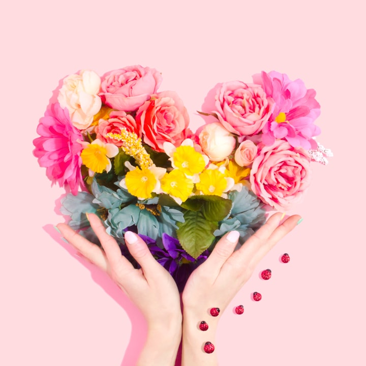 Heart-shaped flower arrangement in someone's hand for Mother's Day