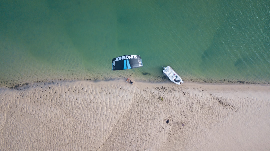 top-view of white boat docked on shore