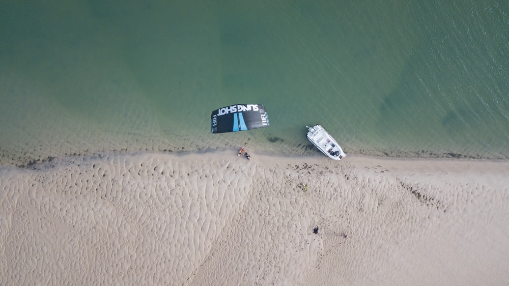 top-view of white boat docked on shore