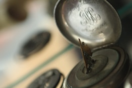 A person examining a vintage watch under soft lighting, showcasing its intricate details.