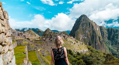 woman facing machu picchu machu picchu teams background