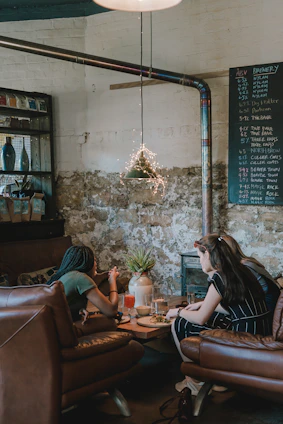 A cozy coffee shop scene where two people are laughing and connecting over a date.