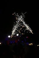 A festive evening gathering with red, white, and blue decorations illuminating the scene.