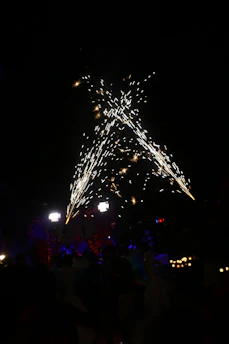 Close-up of certification documents alongside fireworks products on a factory table.