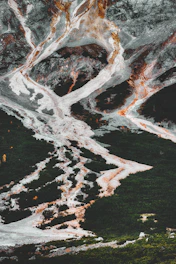 A serene landscape showcasing a complex ultrabasic alkaline carbonatitic mineral outcrop with insightful data overlays.
