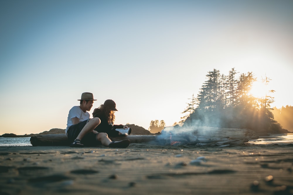 man and woman near bonfire