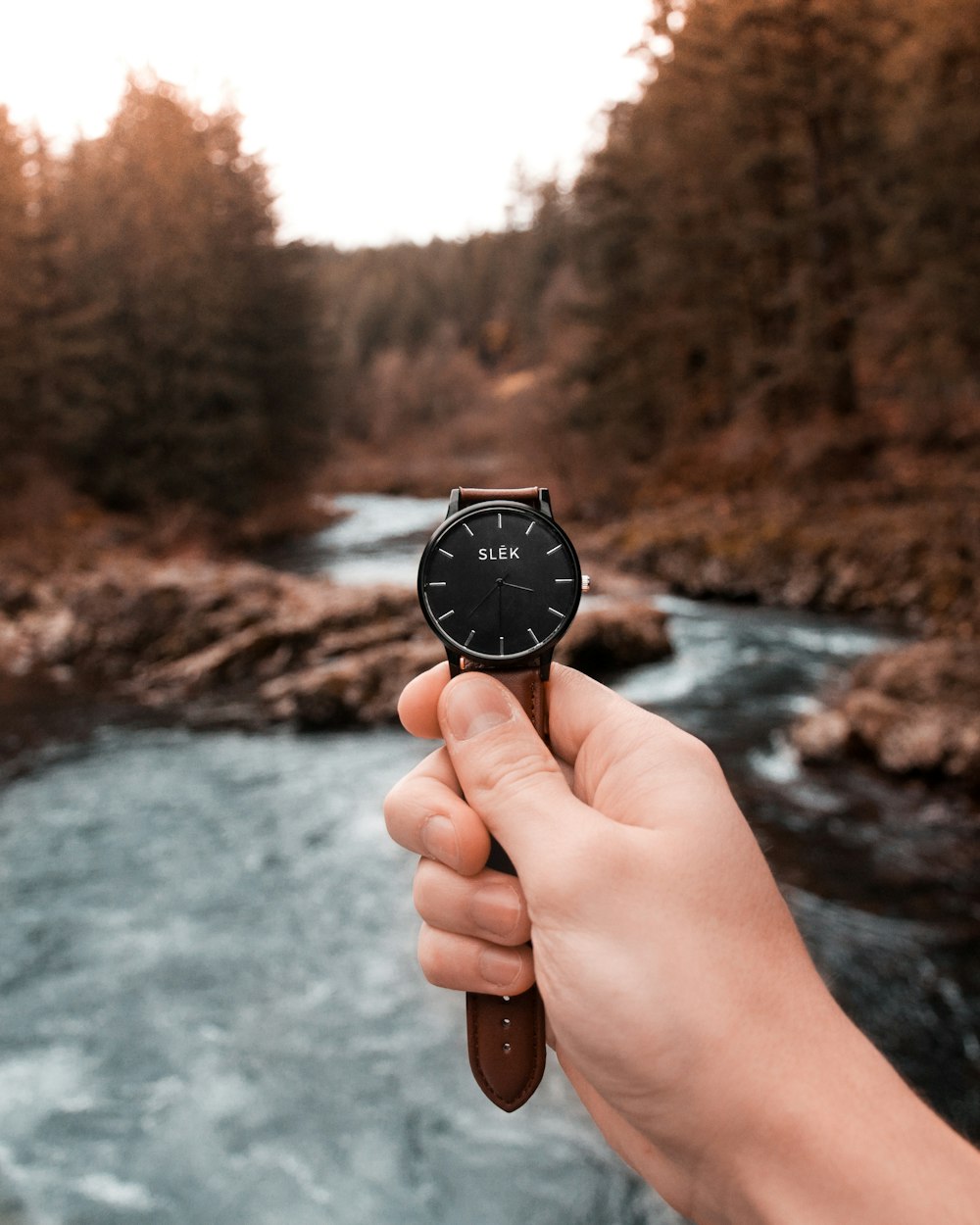 person holding Slek analog watch