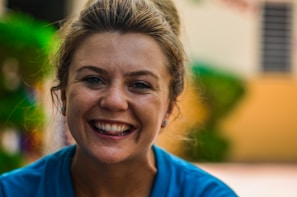 Close-up portrait of a friendly female teacher in a blue-themed classroom