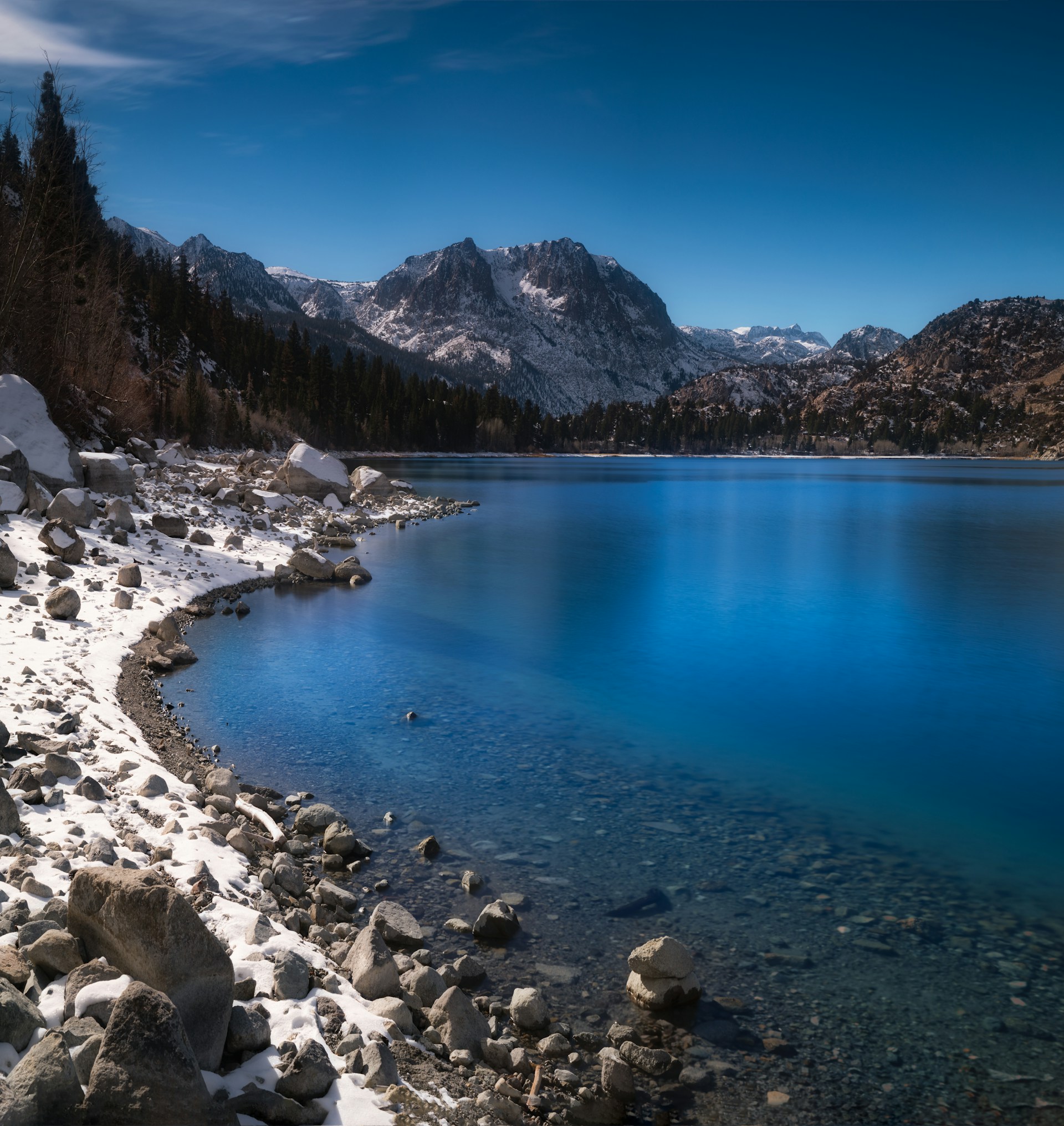 A vibrant thumbnail of a serene mountain lake reflecting the clear blue sky.