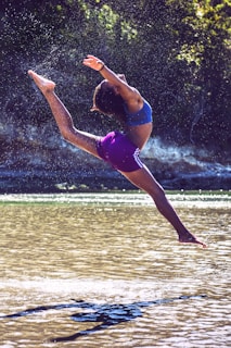 woman bending on body of water