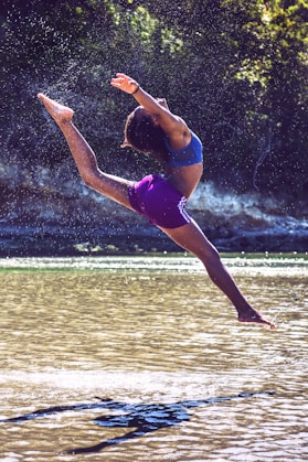 woman bending on body of water