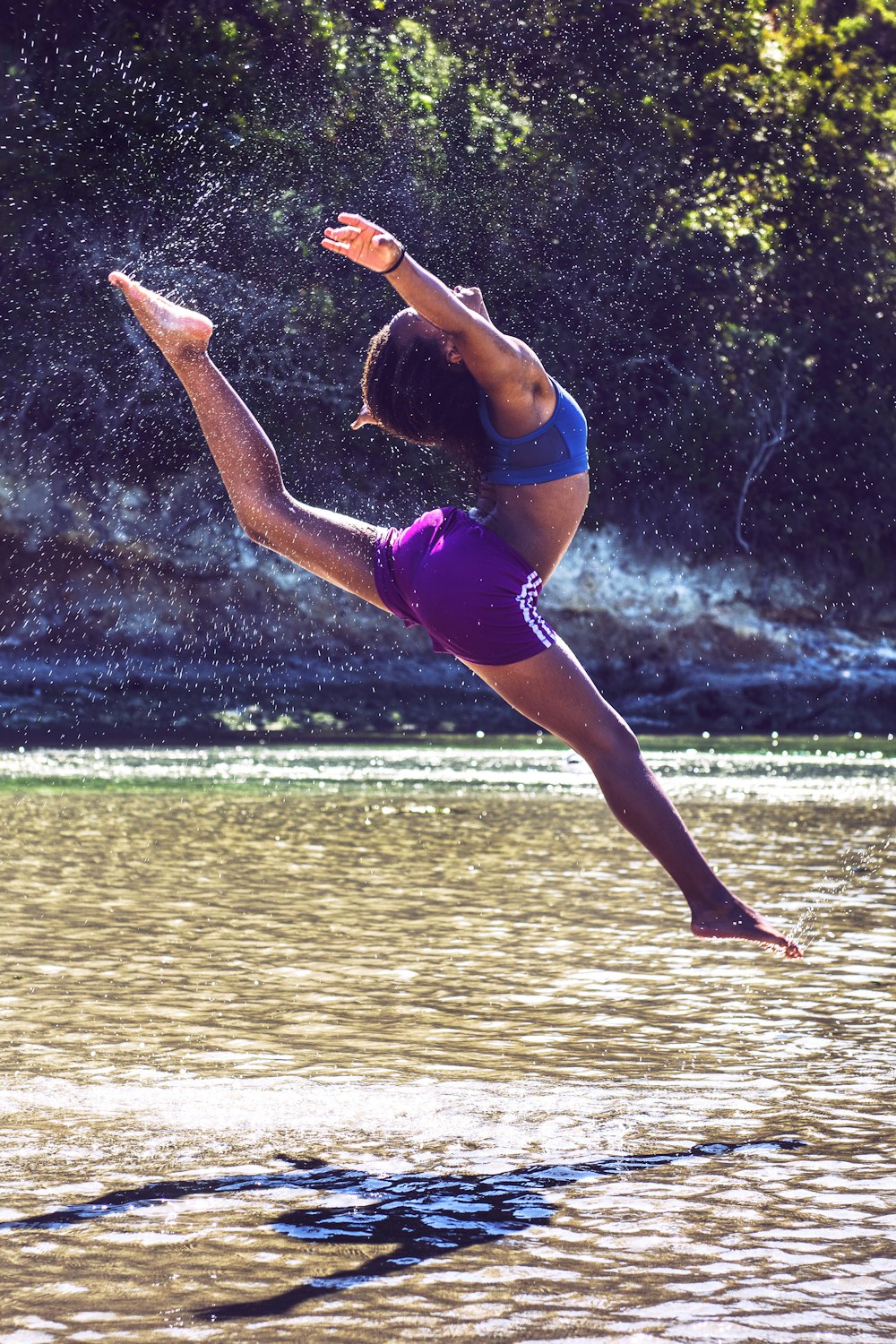 woman bending on body of water