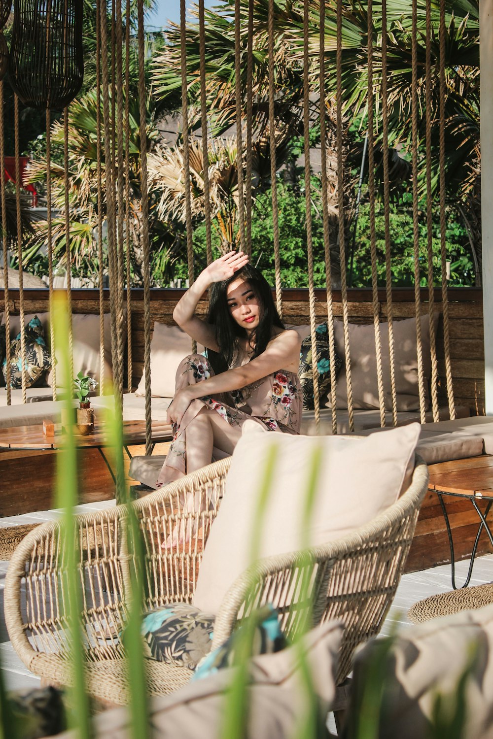 woman raising hand sitting on bench