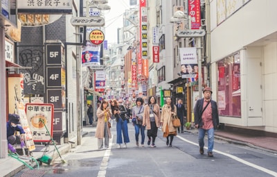 A friendly tour guide sharing insights with travelers in a bustling Tokyo street.