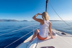 woman sitting on yacht looking mountain