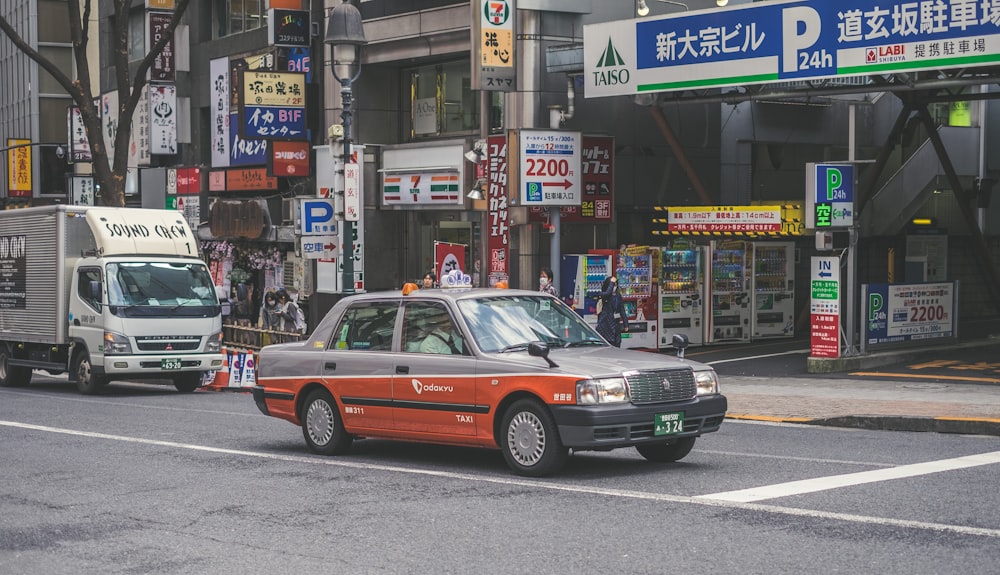 red and grey car on road