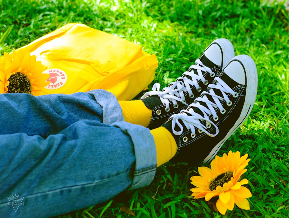 person wearing pair of black-and-white low-top sneakers