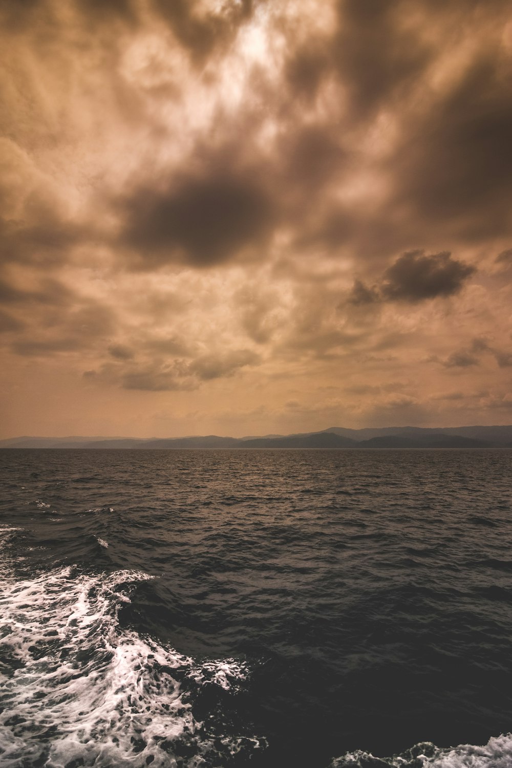 body of water under cloudy sky