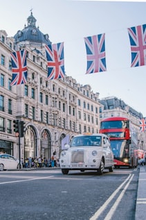 photo of car and bus near castle