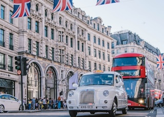 photo of car and bus near castle