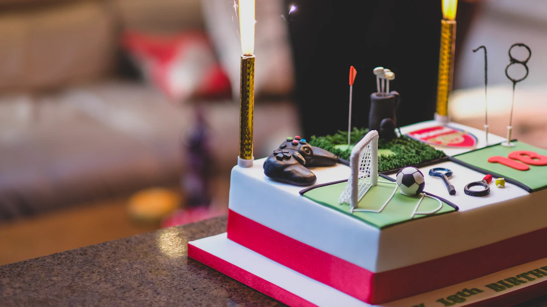 Football birthday cake for men decorated with green fondant field and football