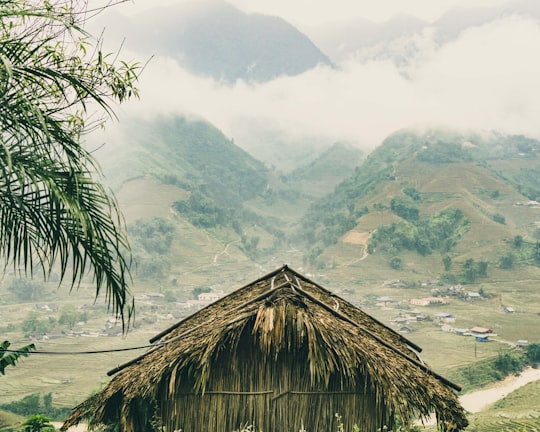 brown nipa hut near mountain in Sapa Vietnam