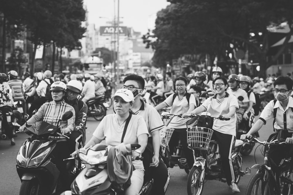 greyscale photo of people riding bikes