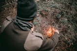 man making fire with grass
