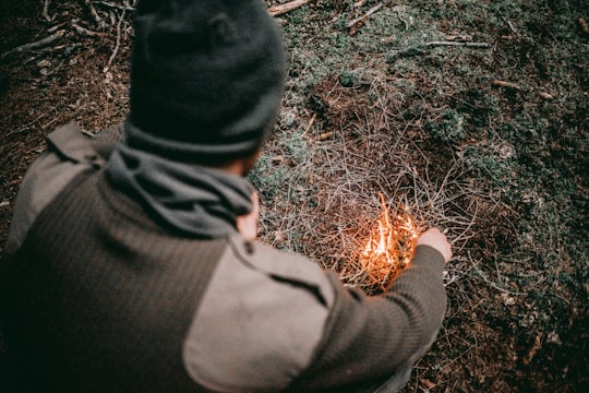 man making fire with grass in Burkat Poland