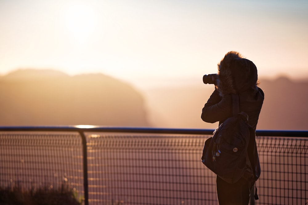 rule of thirds photography of person holding camera