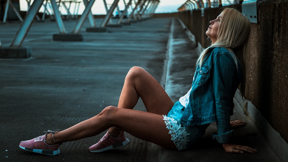 woman looking upward while resting down on road