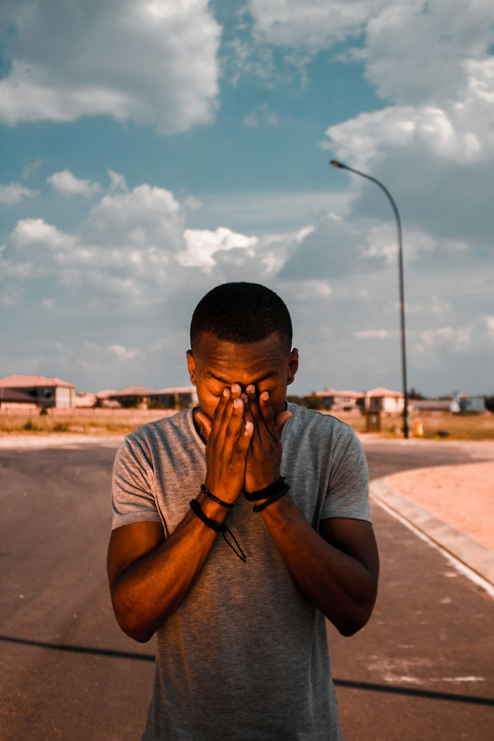 man scratching his face using his hands