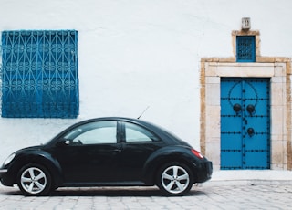 black beetle car near house