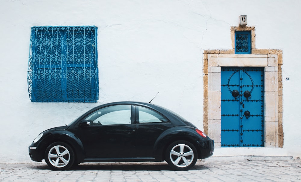 black beetle car near house