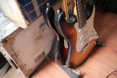 Hard case for guitar displayed on a wooden floor with soft lighting