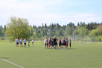 Group playing sports together in a sunny park.