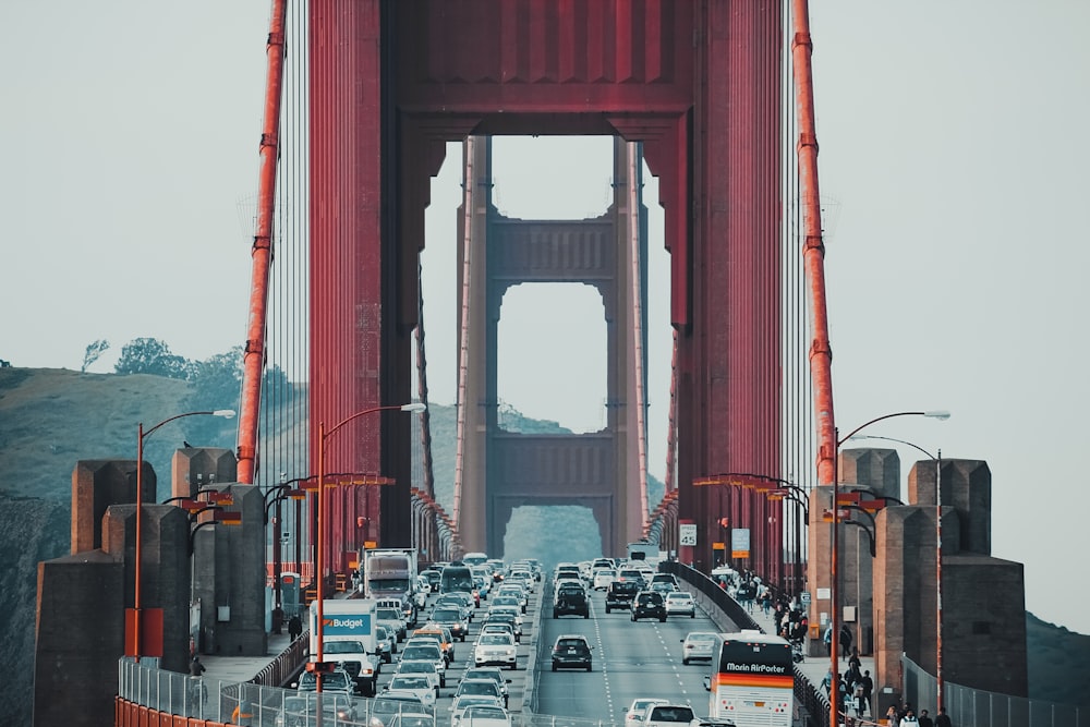 vehicles crossing Golden Gate Bridge at daytime