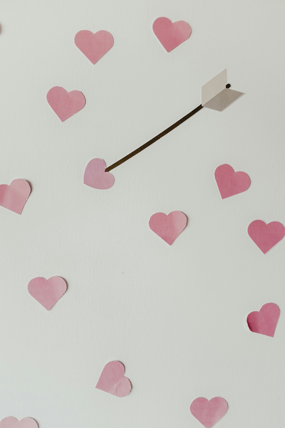 gray arrow in pink heart illustration